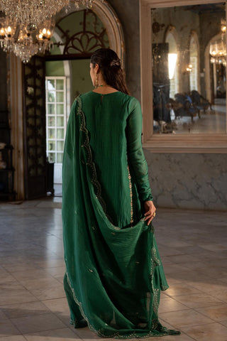 Model showcasing the back of the Ahiliya kurta set made from Malai Chanderi fabric. It has Kurta, Pant and Dupatta in the set.