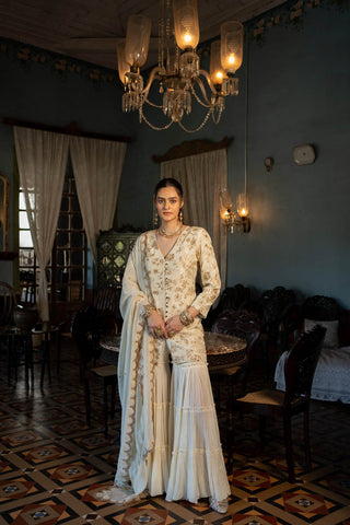 Featuring a self–woven Russian jacquard kurti paired with sharara and organza base dupatta with antique gold resham and embellished hand work. Designed by Paulmi and Harsh.