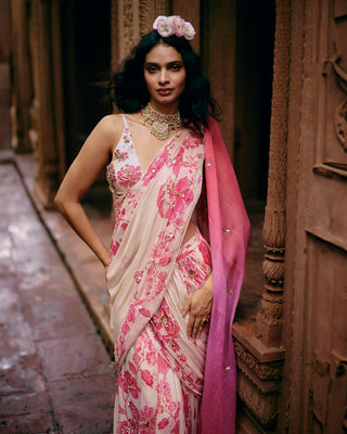 An ivory abstract floral hand–embroidered saree in lightweight georgette that is pre-stitched for easy wear. It is paired with a matching printed hand-embroidered bralette blouse, perfect for the festive season.