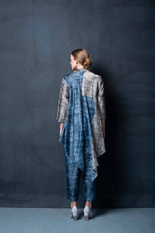 Back look of  two piece dupion silk set comprised of geometrical abstract print, asymmetrical hemline and parallel pants. 