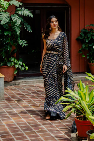 The model is walking freely in black printed pre-stitched georgette saree.