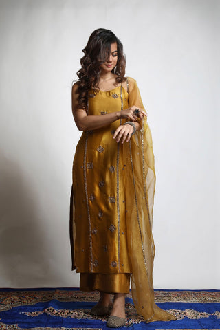 Featuring a straight Kurta embroidered with intricately designed motifs. Paired with matching Wide legged Pants and an embroidered Dupatta. Kurta made from Dupion Silk, Pants from Dupion Silk and Dupatta from Organza material