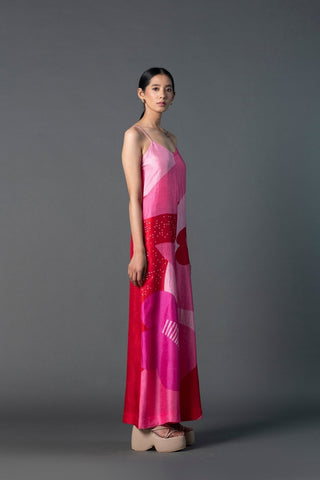 Model wearing fuchsia sequin jumpsuit, styled for a glamorous party look.