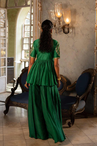 Back look of Pnh Emerald Green chiniya silk peplum set paired with cotton silk base palazzo