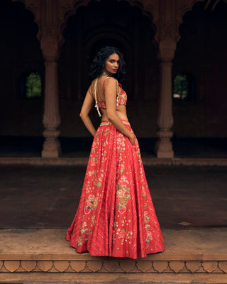 A close up look of an ethereal crimson lehenga in a combination of floral, leheriya and abstract floral prints, with delicate zardozi and aari hand-embroidery.