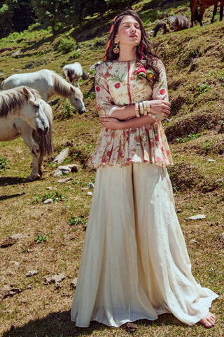 Ivory floral print peplum, embellished with mirror, sequins and resham thread work detailed with hand embellished buttons at front. It is paired with off–white palazzos.