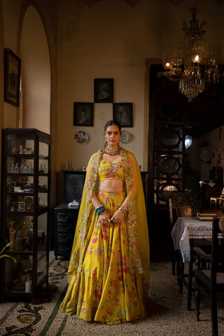 Featuring a lime yellow lehenga set in Paulmi and Harsh signature print, paired with a silk blouse and tissue dupatta, heavily embellished with hand embroidery and detailing of beads and sequins.