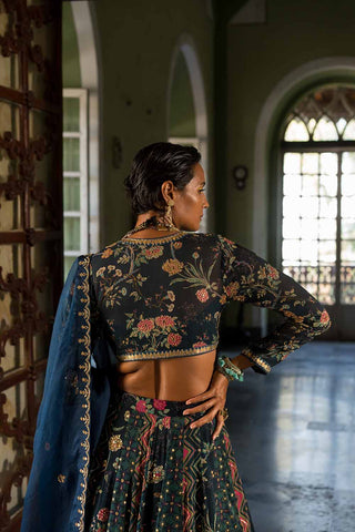 A close up look from back long sleeves blouse in paulmi and harsh floral print with issue dupatta.