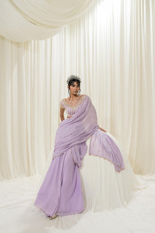 Featuring Lavender pre–stitched saree set paired with a satin organza hand–embroidered blouse in stripes print.