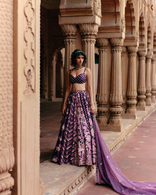 A multi print floral lehenga set featuring prints of chintz jaal, all–over florals, leheriya and buttis. It has a butti print hand embroidered blouse and an organza dupatta hand-embroidered in scallops.