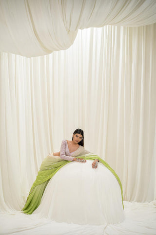 Model posing on an object to give a look of the saree