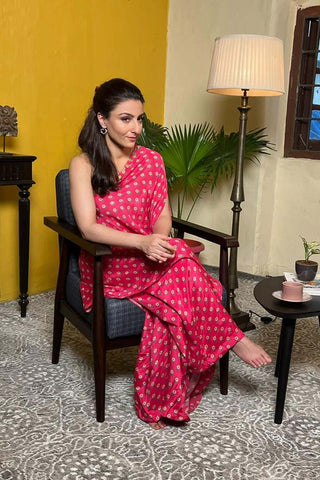 Soha Ali Khan showcases effortless elegance in Paulmi and Harsh beautiful butti printed one shoulder dress in rani pink, with small bell detailing on the neck and is paired with same print palazzos.