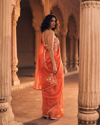 A close up look from the back of the blouse and the hand-embroidery chintz motifs in the saree