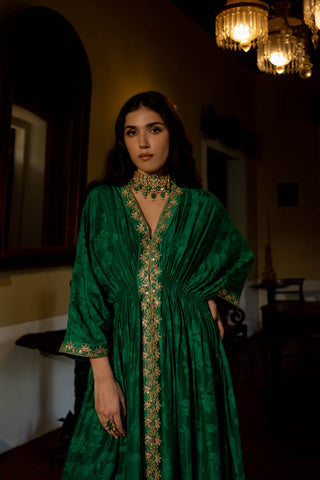 Model in Paulmi and Harsh Caftan set with pant showcasing a close up look of the border is hand embroidered using mirror, resham, sequins, nakshi and cutdana.