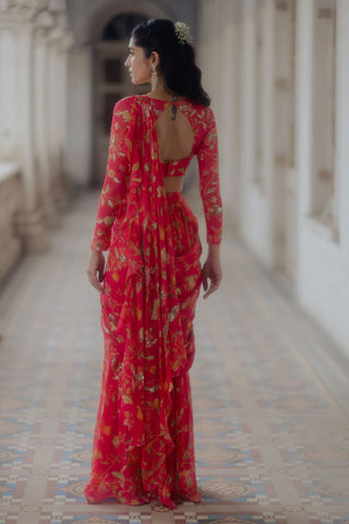 A georgette pink pre-stitched pre-drapped saree set available in all sizes to pre-order and ship in 6 days. The model showcasing the dupatta and blouse from back.