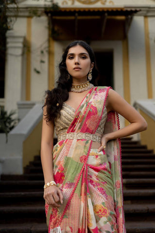 A pre-stitched sari in a printed georgette fabric with naksha print. Designed by Paulmi and Harsh this sari has been edged with crochet border lace, it is paired with hand embroidered cutdana belt and deep v-neck blouse with attached noodle straps with delicate details using zari, cutdana, pita work and nakshi.