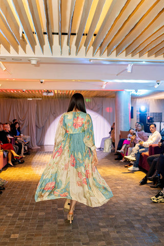 Rear angle shot ivory with multicoloured floral print placement maxi dress, crafted from smooth and breathable habutai silk at Australian Fashion Grandeur runway.