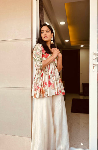 Model posing to show the peplum top and palazzo pant. A perfect Indian Fashion floral print on modern style.