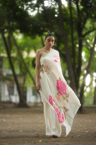 A rose and anar placement print one shoulder dress with coin detailing on the neck, paired with off–white pants designed by Paulmi and Harsh. A perfect dress for vacation, holiday, beach, casual, lunch party, girls day out wear.