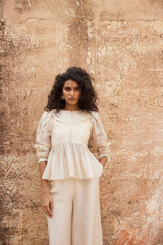 Ivory Silk Floral Cutwork Peplum Top Trouser Co-ord Set designed by Paulmi and Harsh. A perfect look for a beach wear, party, summer wear, dinner date, a dress to flaunt and style, an every day wear.