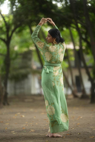 Back look of the A gorgeous white rose placement print wrap– around dress in fern green. Elegant and versatile. Designed by Paulmi and Harsh