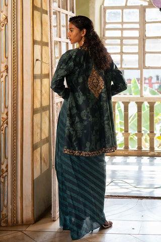 A model showing the look from the back. The pre draped lehriya Choga paired with floral print and antique gold tones on Jacket. A perfect look for all occasions.  