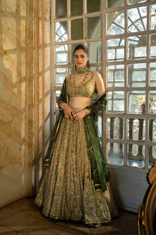 Featuring a sage green delicately embroidered lehenga set in paulmi and harsh signature combination prints paired with a tissue dupatta with antique gold hand embroidery.