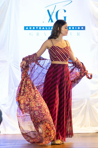 Chic and graceful purple jacket set with all-over floral embellishment on the jacket and blouse with stripy palazzo pants.