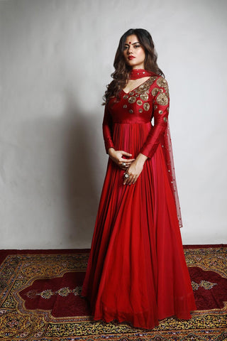 Featuring an Anarkali with a yoke embroidered with intricately designed Chakra motifs attached to kalis in varied shades of Red and Rani Pink.