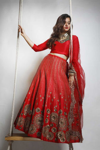 Red chakra lehenga designer wedding bridal attire for wedding pheras or engagement ceremony.