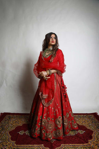 The red chakra lahenga designed by Mona and Vishu is a perfect brial wedding attire for a big day