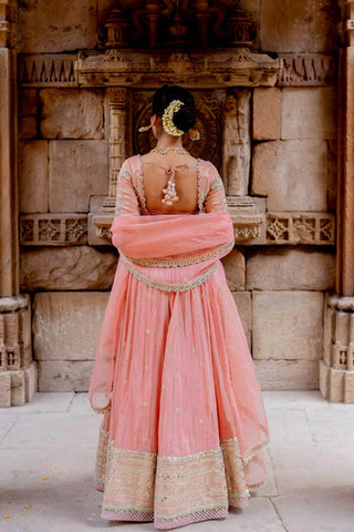 Model posing to give the look of lehenga and blouse from the back