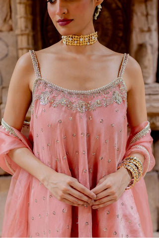 The close up look rose pink flared top, hand embroidered with resham, dori, sequins and pearls in zari tissue base. It has a fit n flare look with noodle straps at the shoulder.