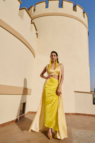 Yellow striped printed jacket with embroidery on the shoulder paired with raw satin striped bustier and draped skirt.